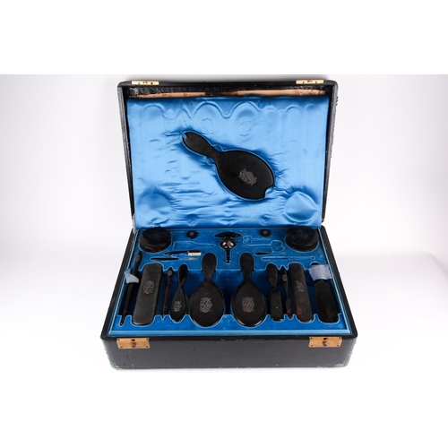 476 - A large late 19th-century leather travel vanity case, the fitted blue silk interior with tortoiseshe... 