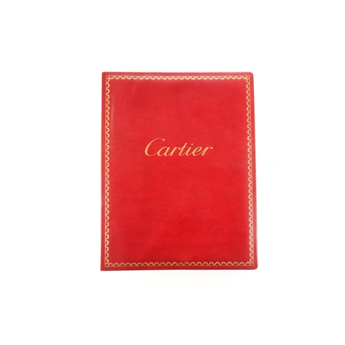 478 - Cartier: a rare salesperson's catalogue, (c.1980s), red leather bound and containing seventeen large... 