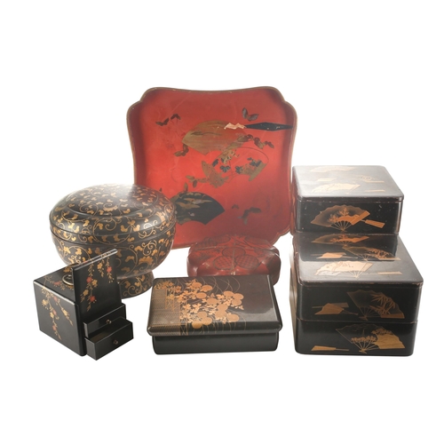 97 - A small collection of Japanese lacquered boxes, and a lacquered tea tray, Meiji and later, stacking ... 