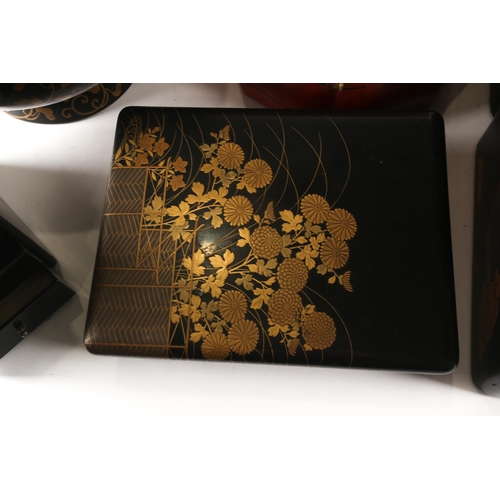 97 - A small collection of Japanese lacquered boxes, and a lacquered tea tray, Meiji and later, stacking ... 