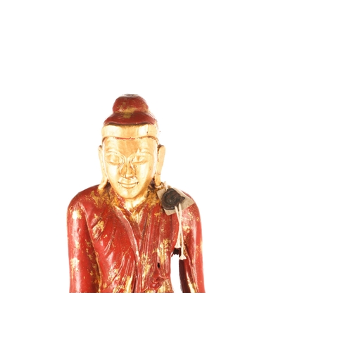 98 - A Burmese carved wood and cinnabar lacquered and parcel-gilt figure of a standing Buddha. Standing u... 