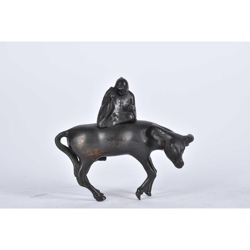 152 - A Chinese bronze figure of a man upon a water buffalo, Qing, 18th/19th century, 15.5cm high; and a p... 