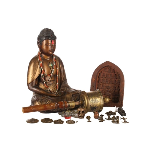 157 - A Nepalese terracotta Buddha plaque, early 20th century, 14.5cm x 19cm; a Tibetan brass prayer wheel... 