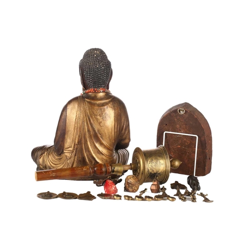 157 - A Nepalese terracotta Buddha plaque, early 20th century, 14.5cm x 19cm; a Tibetan brass prayer wheel... 