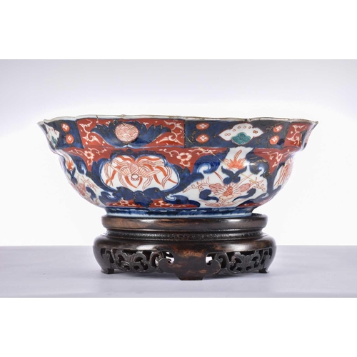 159 - A Japanese Imari porcelain bowl, 19th century, with barbed rima and pnels of birds and flowers, four... 