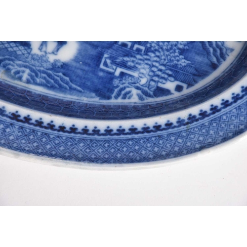 163 - Three Chinese export blue & white plates, Qing, 18th century, comprising a dished plate painted with... 