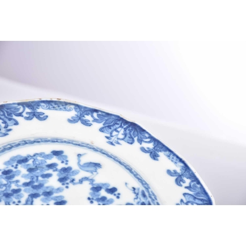 163 - Three Chinese export blue & white plates, Qing, 18th century, comprising a dished plate painted with... 