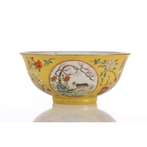 170 - A Chinese yellow ground bowl, 20th century, painted with medallions of goats by blossoming trees wit... 