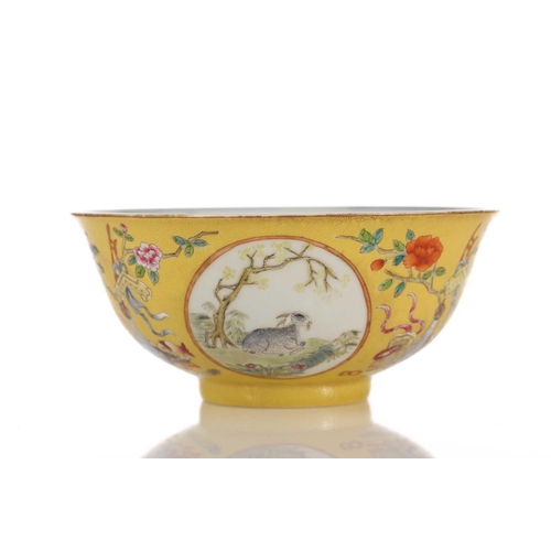 170 - A Chinese yellow ground bowl, 20th century, painted with medallions of goats by blossoming trees wit... 