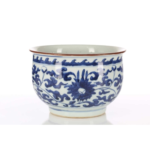 179 - A Chinese blue & white deep sided bowl, in the Ming style, with lotus flower decoration beneath a ba... 