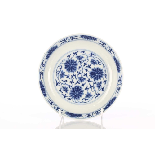 181 - A Chinese porcelain blue & white dish, painted with lotus flowers and tendrils within a similar bord... 