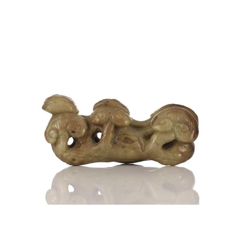 183 - A Chinese jade brush rest, 20th century, carved as a group of lingzhi, the stone a pale green and br... 