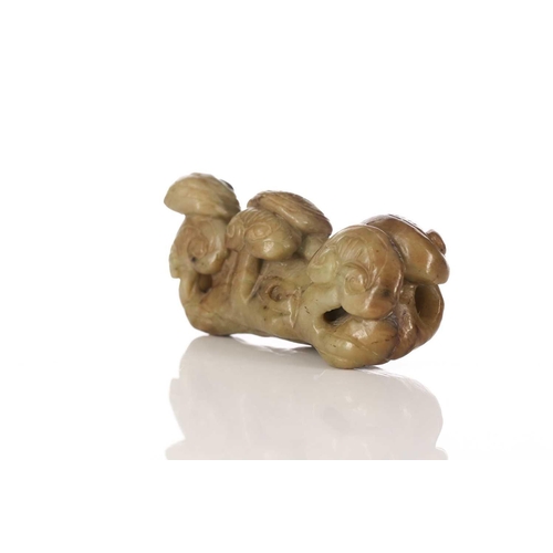 183 - A Chinese jade brush rest, 20th century, carved as a group of lingzhi, the stone a pale green and br... 