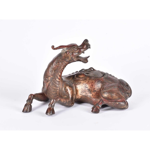 185 - A Chinese bronze censer, modelled as a Pixiu in recumbent pose, its snarling head looking over its s... 