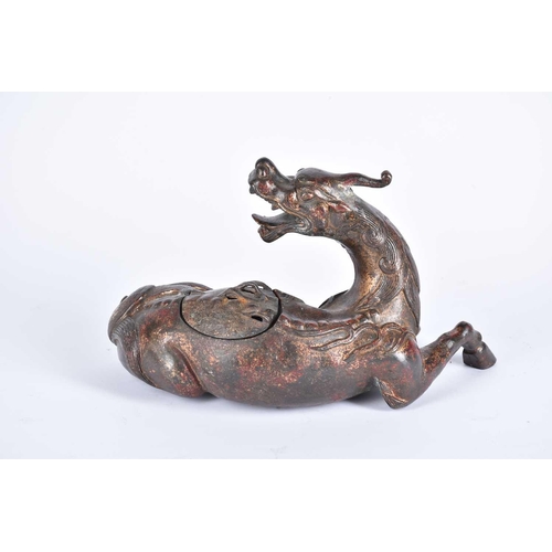 185 - A Chinese bronze censer, modelled as a Pixiu in recumbent pose, its snarling head looking over its s... 