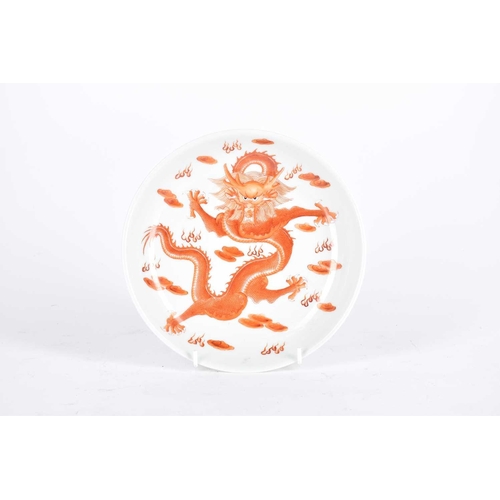 186 - A Chinese porcelain dragon dish, painted with an iron red dragon with white teeth and claws, amongst... 