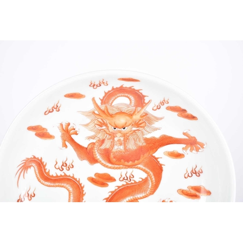 186 - A Chinese porcelain dragon dish, painted with an iron red dragon with white teeth and claws, amongst... 