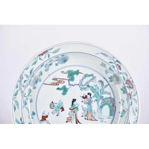 193 - A Chinese doucai basin, painted with two standing females with six boys at play, within a landscape ... 