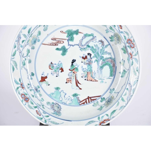 193 - A Chinese doucai basin, painted with two standing females with six boys at play, within a landscape ... 