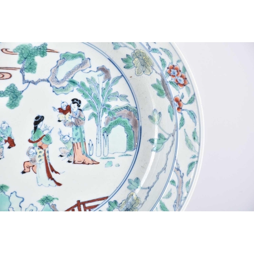 193 - A Chinese doucai basin, painted with two standing females with six boys at play, within a landscape ... 