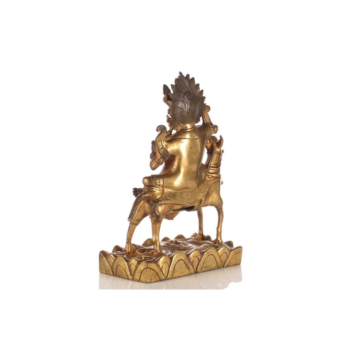 194 - A Sino-Tibetan gilt-bronze figure of Palden Lhamo riding sideways on a mule holding a kapala in her ... 