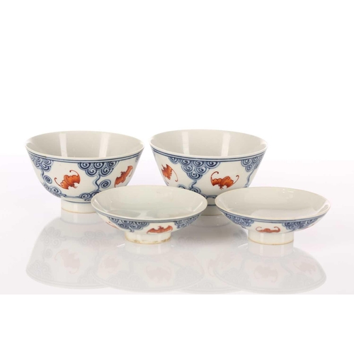 196 - A pair of Chinese porcelain Wufu ( five fortunes) bowls and covers, each piece painted with five red... 