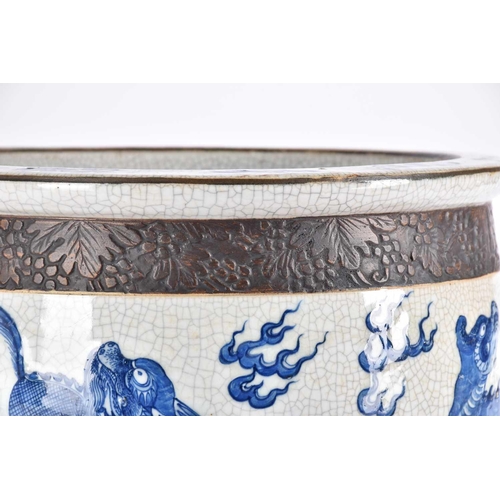 197 - A Chinese crackle glaze blue & white jardiniere, Qing, late 19th century, finely painted with shallo... 