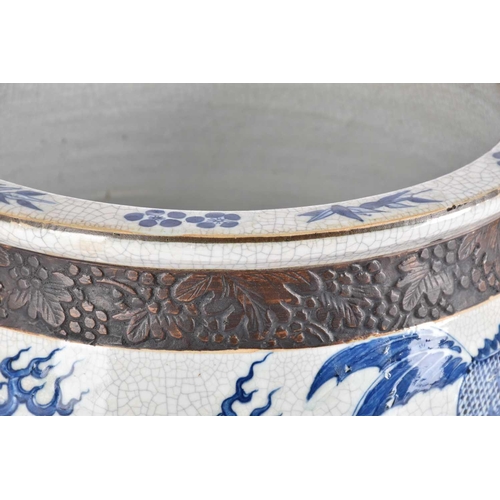 197 - A Chinese crackle glaze blue & white jardiniere, Qing, late 19th century, finely painted with shallo... 