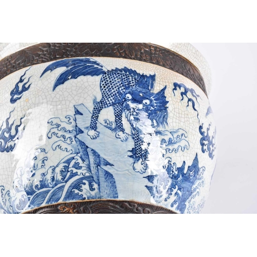 197 - A Chinese crackle glaze blue & white jardiniere, Qing, late 19th century, finely painted with shallo... 