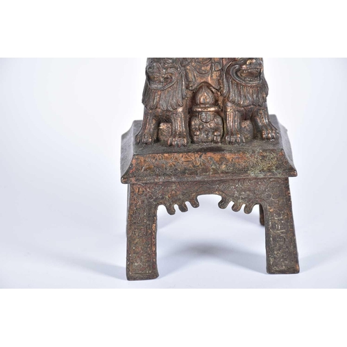 203 - A Chinese bronze figure of Buddha, seated upon a lion throne before a flaming mandorla, traces of re... 