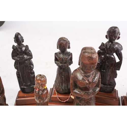 209 - A collection of Indian carved wood figures, 18/19th century and later, mostly depicting standing fem... 