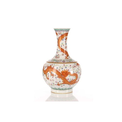 219 - A Chinese famille rose dragon vase, the wisted neck painted with a writhing iron red and gilt dragon... 