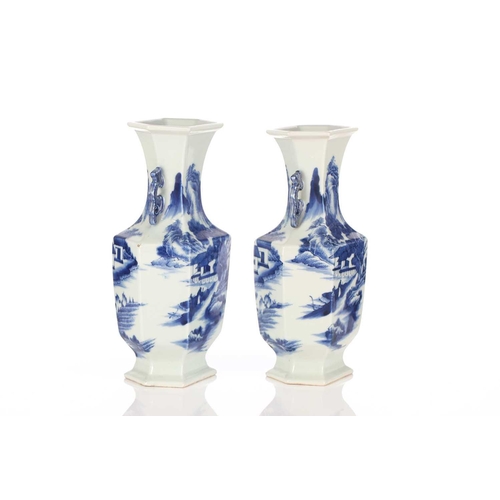 224 - A pair of Chinese blue & white hexagonal vases, painted with figures heading towards a mountain retr... 