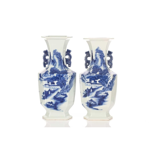 224 - A pair of Chinese blue & white hexagonal vases, painted with figures heading towards a mountain retr... 