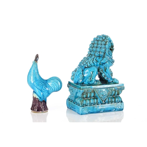 240 - A Chinese turquoise glazed temple lion, 20th century, its paw upon a pup, seated on a raised rectang... 