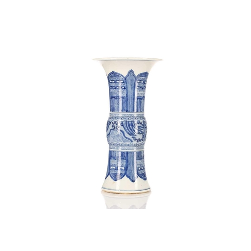 245 - A Chinese blue and white Gu form vase, the centre painted with Taotie masks between leaves and blade... 