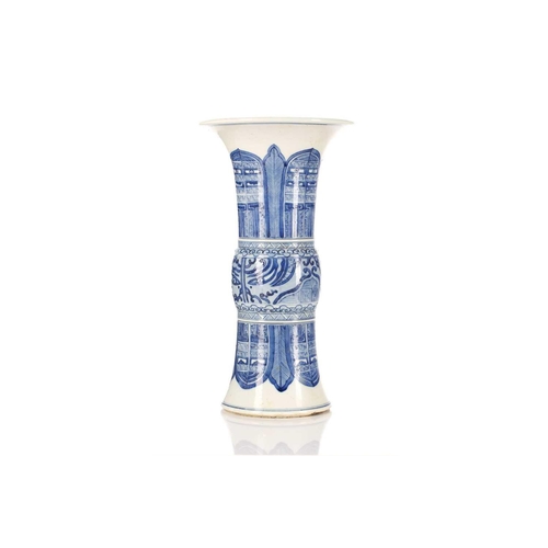 245 - A Chinese blue and white Gu form vase, the centre painted with Taotie masks between leaves and blade... 