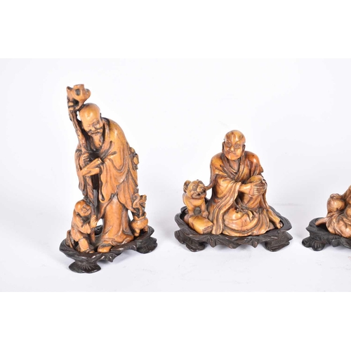 253 - Four Chinese soapstone carvings, late Qing to early 20th century, three as deities Shou Lao, Budai a... 