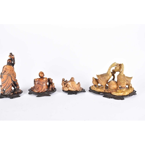 253 - Four Chinese soapstone carvings, late Qing to early 20th century, three as deities Shou Lao, Budai a... 