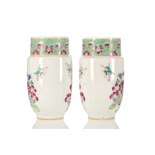 260 - A pair of Chinese porcelain vases and covers, of cylindrical form tapering at the base, the covers w... 