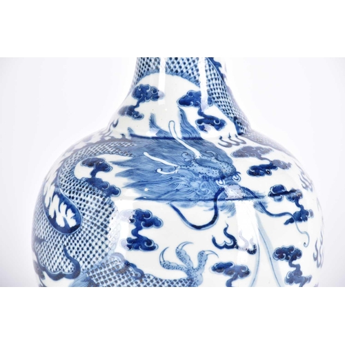 261 - A large Chinese blue & white tianqiuping dragon vase, the flared neck painted with spuming waves abo... 