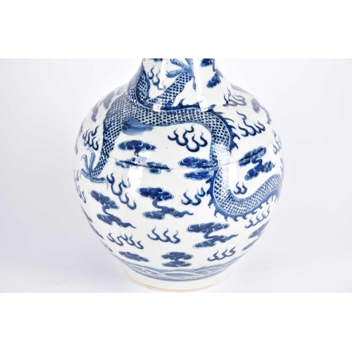 261 - A large Chinese blue & white tianqiuping dragon vase, the flared neck painted with spuming waves abo... 