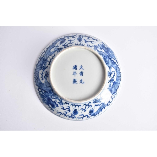 265 - A pair of Chinese blue & white porcelain dragon dishes, painted with a writhing dragon chasing a fla... 