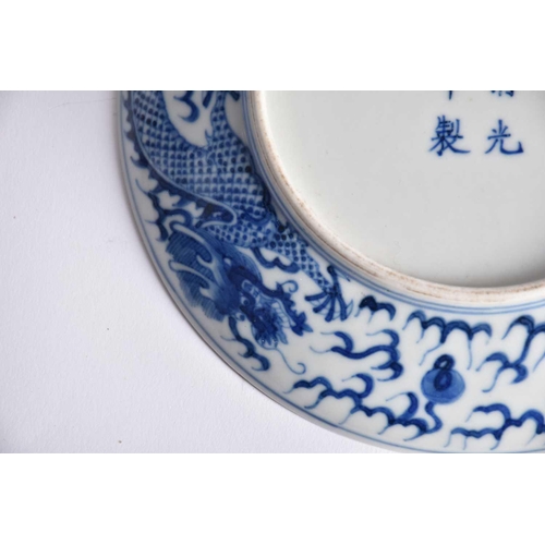 265 - A pair of Chinese blue & white porcelain dragon dishes, painted with a writhing dragon chasing a fla... 