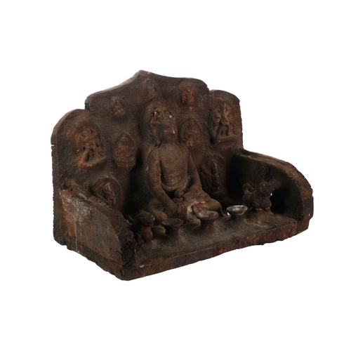 269 - A Nepalese Buddha altar, the wood body with applied terracotta seated Buddha, flanked by temple lion... 