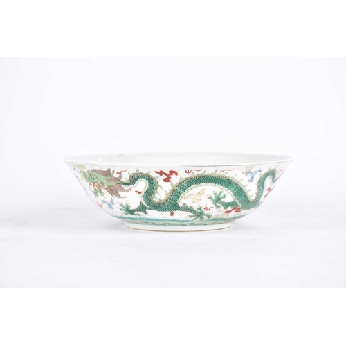 272 - A Chinese famille verte dragon bowl, the interior painted with waves and a rock, the exterior with t... 