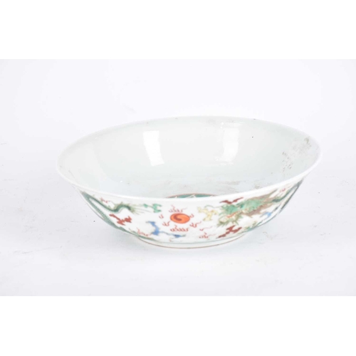 272 - A Chinese famille verte dragon bowl, the interior painted with waves and a rock, the exterior with t... 