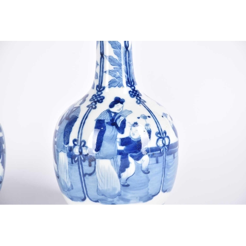 276 - A near pair of Chinese blue & white bottle vases, the neck painted with peaches and flowers above ba... 