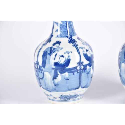 276 - A near pair of Chinese blue & white bottle vases, the neck painted with peaches and flowers above ba... 