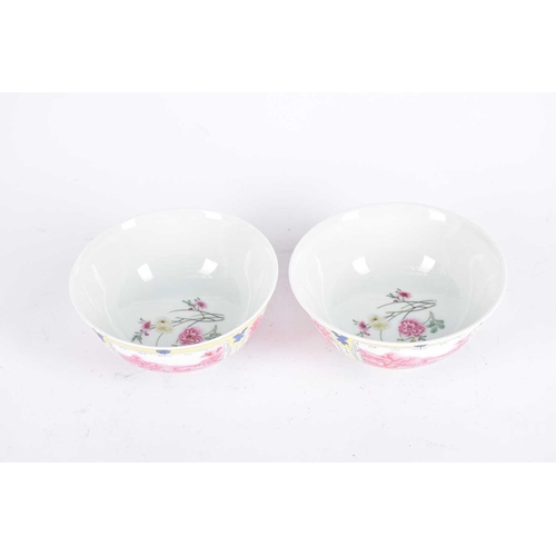 277 - A pair of Chinese famille rose bowls, the interiors painted with a sprig of peony, the exterior with... 